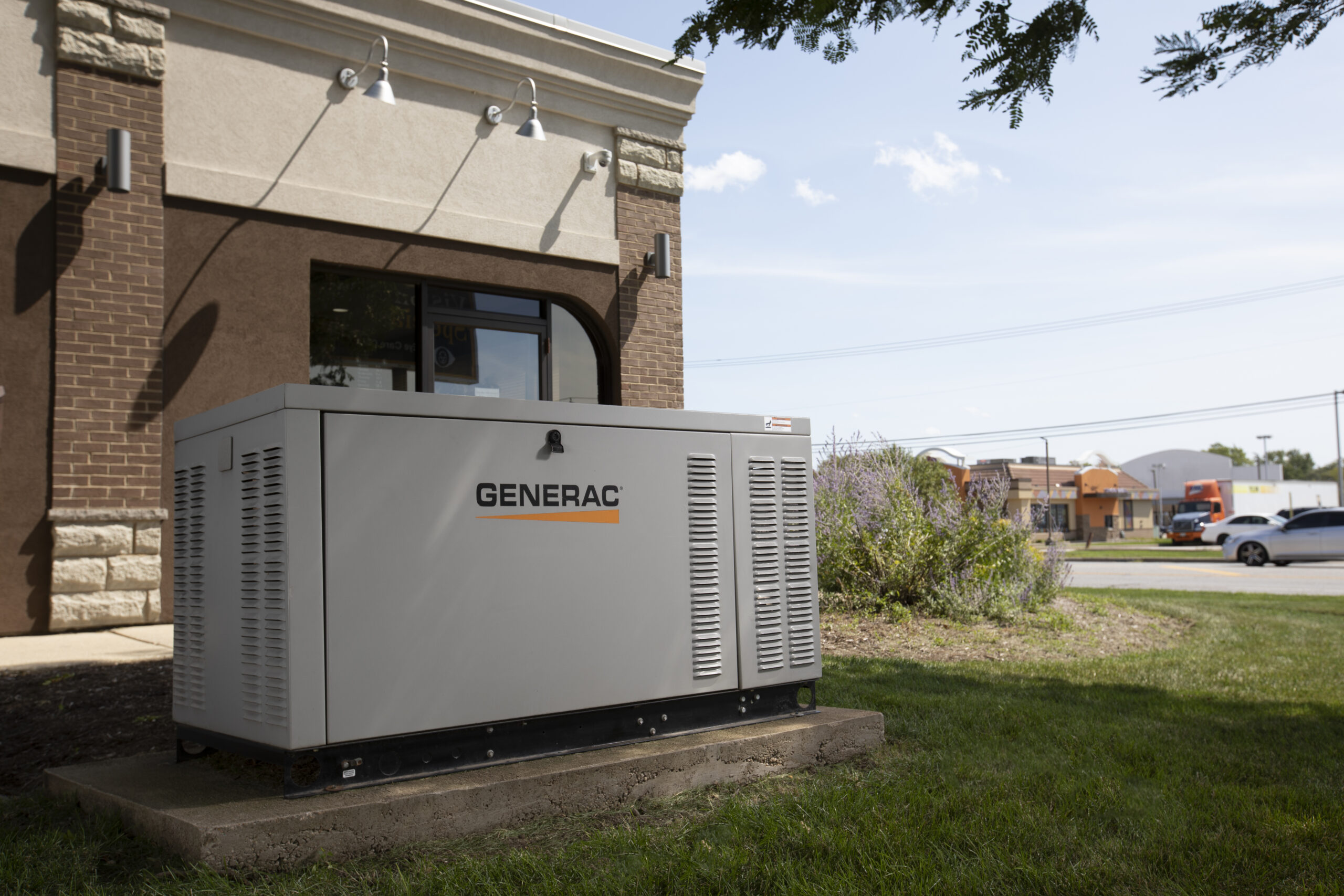 “Generac commercial standby generator installed outside a retail building.