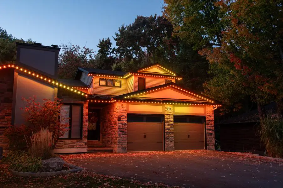 Home with warm amber lighting on the roofline at dusk