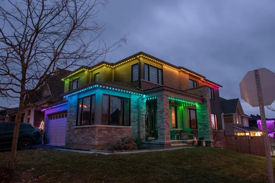 Modern two-story home, warm gold and green permanent lighting