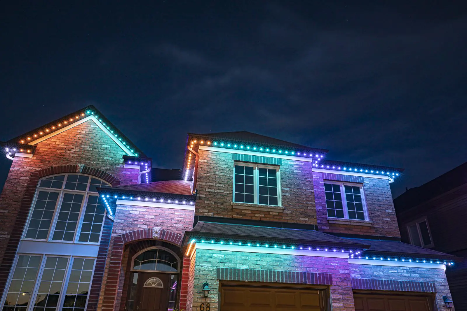 Same home with permanent lighting switched to a teal, purple and orange scene